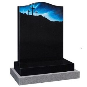 Black granite headstone with painted cross and scene