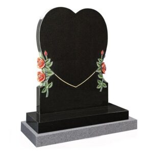 A black granite heart with carved roses and leaves